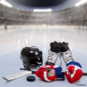 Picture of Hockey Equipment on Ice of Crowded Arena